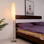 White cylindrical floor lamp 180cm with pleated fabric shade and metal base, minimalist indoor lighting