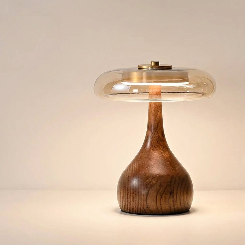 Table lamp with solid walnut timber base and tinted glass disc, warm ambient LED light