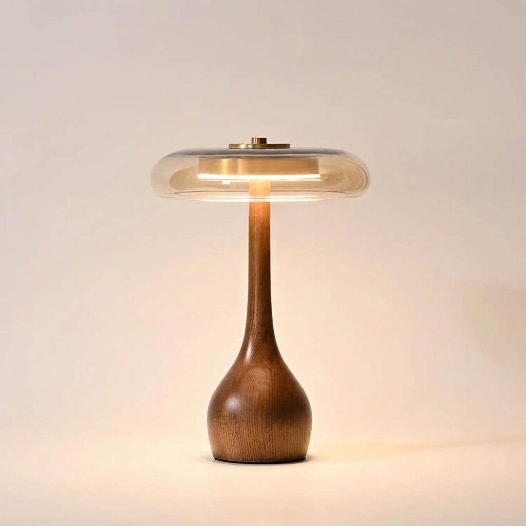 Table lamp with solid walnut timber base and tinted glass disc, warm ambient LED light