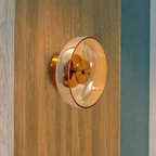 Round wall sconce with brass and glass shade, minimalist LED 1-light indoor fixture