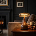Table lamp with solid walnut timber base and tinted glass disc, warm ambient LED light