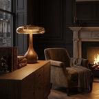 Table lamp with solid walnut timber base and tinted glass disc, warm ambient LED light
