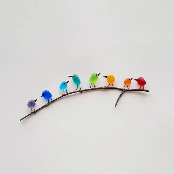 Sea glass wall art with colorful rainbow birds on a wooden branch, recycled material