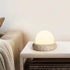 Travertine table lamp with opal glass globe, beige natural stone base, USB rechargeable LED
