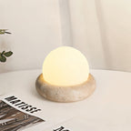 Travertine table lamp with opal glass globe, beige natural stone base, USB rechargeable LED