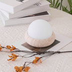 Travertine table lamp with opal glass globe, beige natural stone base, USB rechargeable LED