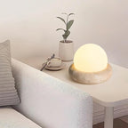 Travertine table lamp with opal glass globe, beige natural stone base, USB rechargeable LED