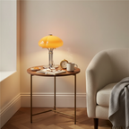 Mushroom table lamp with warm amber glow, cast iron frame and hand-blown glass shade
