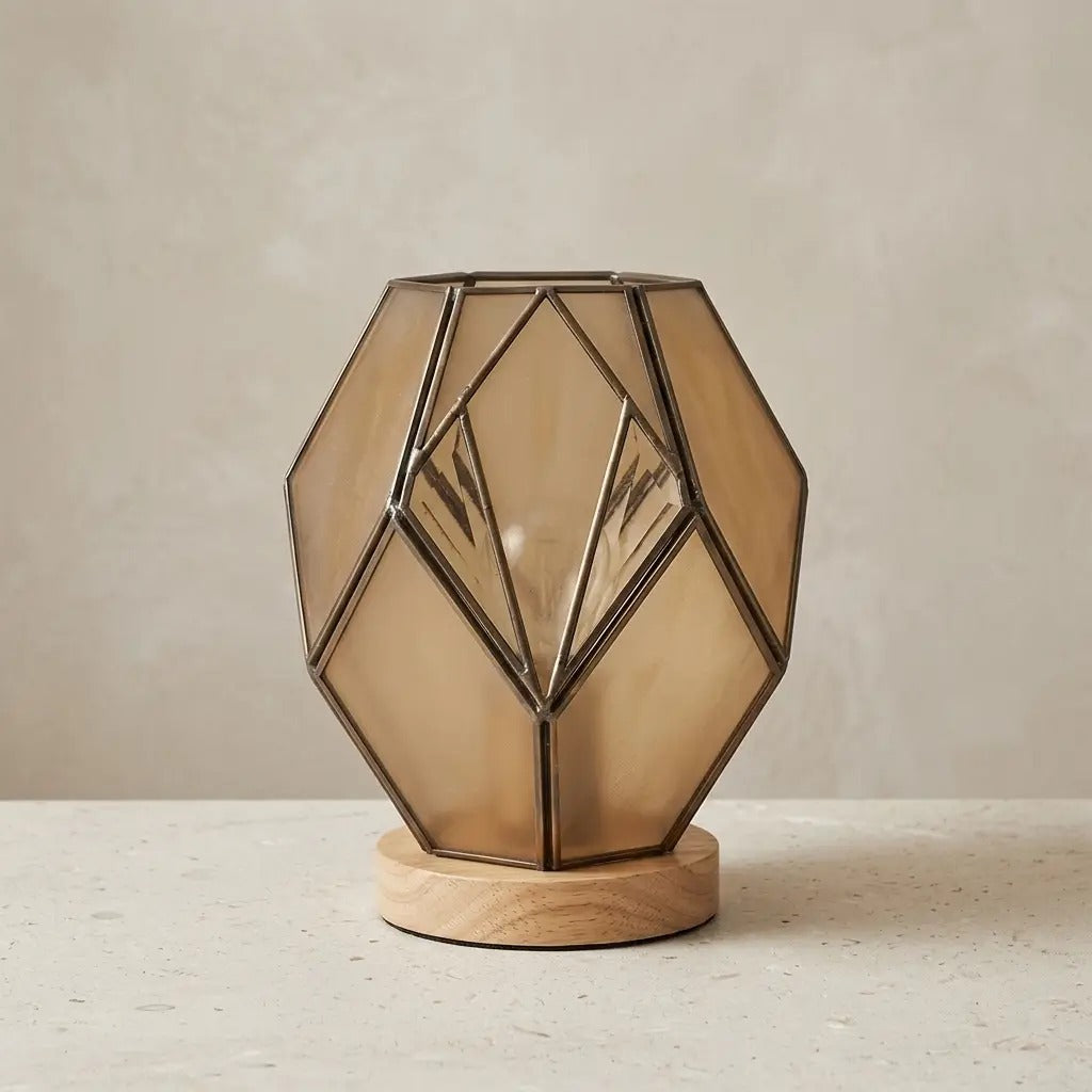Geometric glass table lamp amber with wood base and exposed metal profiles, warm diffused light