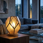 Geometric glass table lamp amber with wood base and exposed metal profiles, warm diffused light