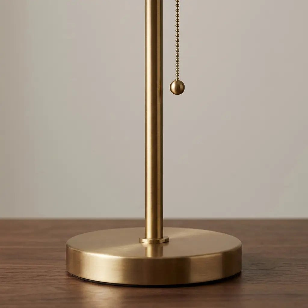 Table lamp with blue pleated fabric shade and brass metal base, soft ambient light