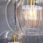 Art deco pendant lamp with ribbed glass shade and brass details, amber or clear glass