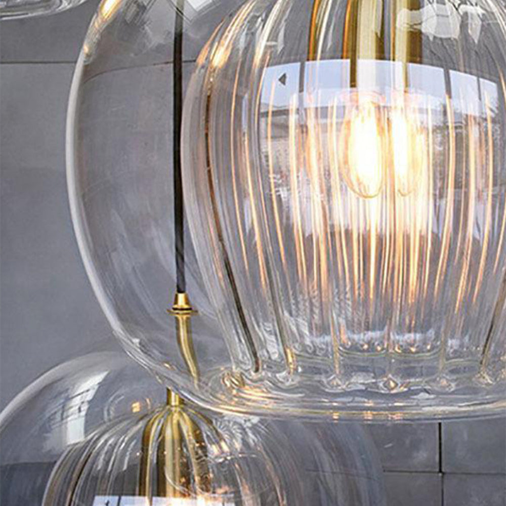 Art deco pendant lamp with ribbed glass shade and brass details, amber or clear glass