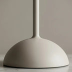 Table lamp with terracotta pleated fabric shade and slim pale matt metal base