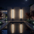 Linear outdoor wall light in black aluminium with warm LED up-down wall wash effect