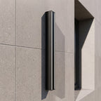 Linear outdoor wall light in black aluminium with warm LED up-down wall wash effect